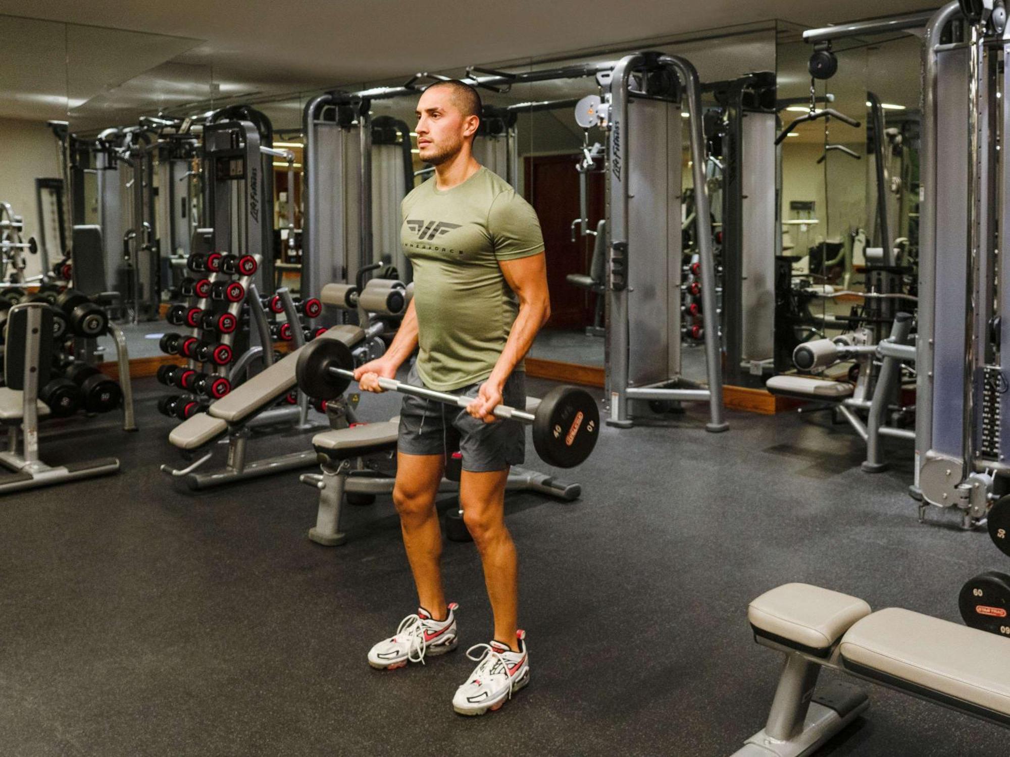 La Cigale Hotel Managed By Accor Доха Экстерьер фото A man performing a barbell shrug